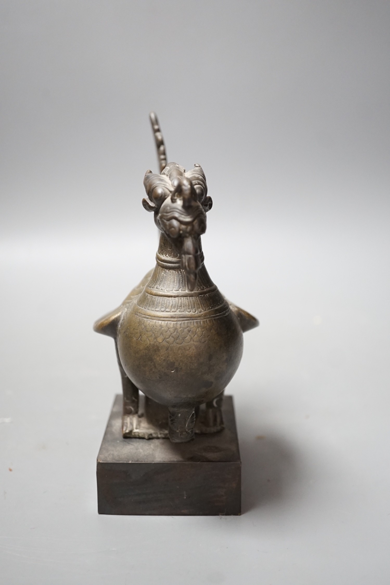 A 19th century Indian engraved bronze bird on plinth, 14.5cm wide